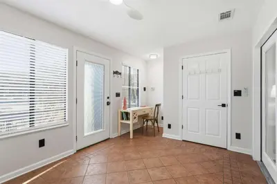 a hallway with a white door and a table at 135 Grande Island Blvd in Panama City Beach