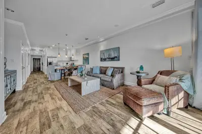 a living room with a couch and a table at Newly renovated overlooking the Seacrest Village Pool and Beach access in Rosemary Beach