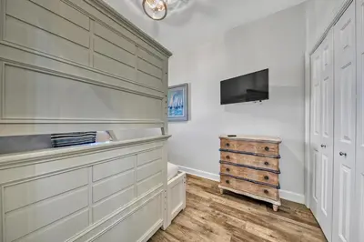 a bathroom with white cabinets and a television and a dresser at Newly renovated overlooking the Seacrest Village Pool and Beach access in Rosemary Beach