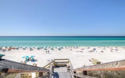 a group of people on a beach with the ocean at Newly renovated overlooking the Seacrest Village Pool and Beach access in Rosemary Beach