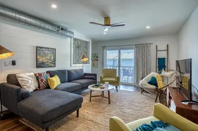 a living room with a couch and a tv at Gulf Views! Only 30 Seconds to the beach Modern Amenities Meets Vintage Charm in Inlet Beach