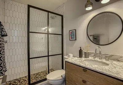 a bathroom with a toilet and a sink and a mirror at Gulf Views! Only 30 Seconds to the beach Modern Amenities Meets Vintage Charm in Inlet Beach