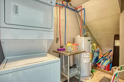 a refrigerator in a kitchen with a table next to it at Gulf Views! Only 30 Seconds to the beach Modern Amenities Meets Vintage Charm in Inlet Beach