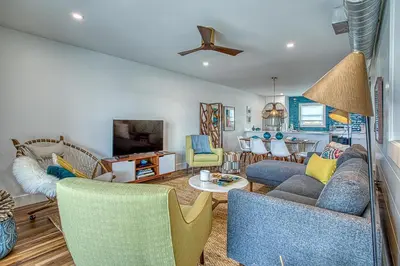 a living room with a couch and chairs at Gulf Views! Only 30 Seconds to the beach Modern Amenities Meets Vintage Charm in Inlet Beach