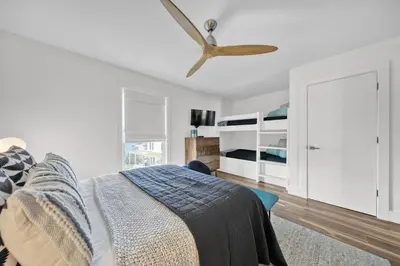 a bedroom with a bed and a ceiling fan at Gulf Views! Only 30 Seconds to the beach Modern Amenities Meets Vintage Charm in Inlet Beach