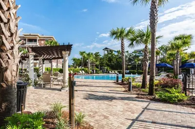 a resort with a swimming pool and palm trees at Overlooking 30A! Great Location! Easy Beach & Pool Access! in Rosemary Beach