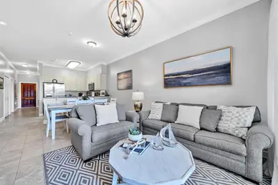 a living room with a couch and a table at Overlooking 30A! Great Location! Easy Beach & Pool Access! in Rosemary Beach