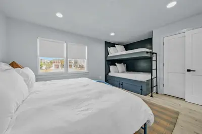 a bedroom with two bunk beds and a window at Gulf Front, Stunning Views! Newly Renovated! Dolphin Watch #1 in Seacrest