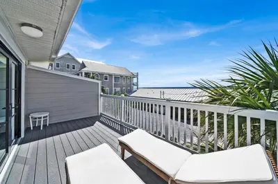 a deck with a couch and chairs on it at Gulf Front, Stunning Views! Newly Renovated! Dolphin Watch #1 in Seacrest