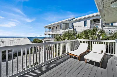 a balcony with two chairs and a view of the ocean at Gulf Front, Stunning Views! Newly Renovated! Dolphin Watch #1 in Seacrest