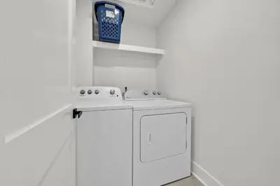 a white kitchen with a stove and a sink at Gulf Front, Stunning Views! Newly Renovated! Dolphin Watch #1 in Seacrest