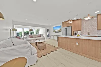 a living room with a couch and a kitchen at Gulf Front, Stunning Views! Newly Renovated! Dolphin Watch #1 in Seacrest