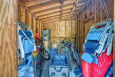 a garage with several bikes parked in it at Magnolia Cottages Seacrest Flirty Flamingo - Pet Friendly Resort Pool & Beach Access! in Seacrest