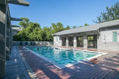 a swimming pool in the backyard of a house at Magnolia Cottages Seacrest Flirty Flamingo - Pet Friendly Resort Pool & Beach Access! in Seacrest