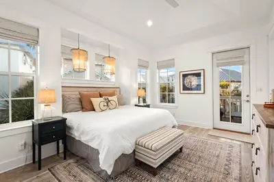a white bedroom with a large bed and windows at Katmanblu - Over 45 Five Star Reviews! Custom-Built! Easy Beach & Pool Access! in Rosemary Beach