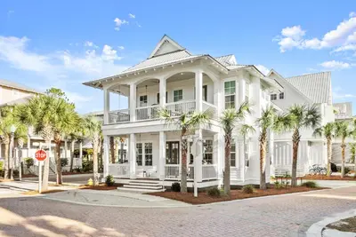a white house with palm trees and a stop sign at Katmanblu - Over 45 Five Star Reviews! Custom-Built! Easy Beach & Pool Access! in Rosemary Beach