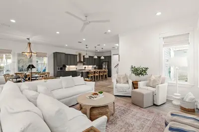 a living room with a white couch and a table at Katmanblu - Over 45 Five Star Reviews! Custom-Built! Easy Beach & Pool Access! in Rosemary Beach