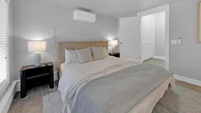 a white bedroom with a large bed and two lamps at Luxury Seacrest Beach Home Community Pool Deeded Beach Access! in Rosemary Beach
