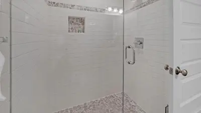 a shower with a glass door in a bathroom at Luxury Seacrest Beach Home Community Pool Deeded Beach Access! in Rosemary Beach