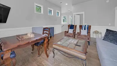 a living room with a table and chairs and a couch at Luxury Seacrest Beach Home Community Pool Deeded Beach Access! in Rosemary Beach