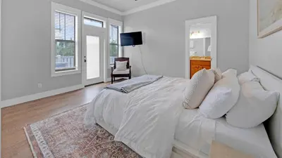 a white bedroom with a bed with white pillows at Luxury Seacrest Beach Home Community Pool Deeded Beach Access! in Rosemary Beach