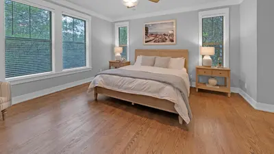 a bedroom with a bed with two night stands and two windows at Luxury Seacrest Beach Home Community Pool Deeded Beach Access! in Rosemary Beach