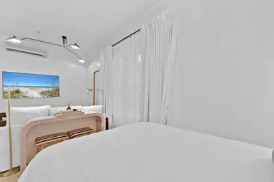 a white bedroom with a bed and a window at Village of South Walton Studio Ground Floor Easy Beach & Pool Access! in Rosemary Beach