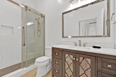 a bathroom with a toilet and a sink and a shower at Village of South Walton Studio Ground Floor Easy Beach & Pool Access! in Rosemary Beach