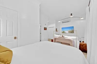 a white bedroom with a bed and a desk at Village of South Walton Studio Ground Floor Easy Beach & Pool Access! in Rosemary Beach
