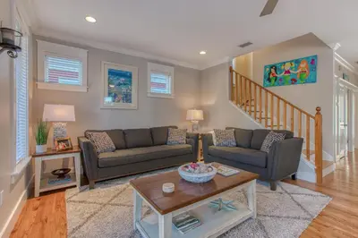 a living room with two couches and a table at 50 yards to the Seacrest lagoon Pool, Walking distance to the beach! in Rosemary Beach