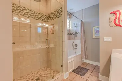 a bathroom with a shower with a glass door at 50 yards to the Seacrest lagoon Pool, Walking distance to the beach! in Rosemary Beach