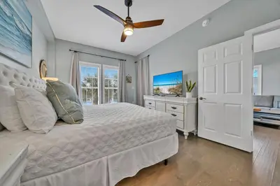 a bedroom with a bed and a ceiling fan at Stunning Village Condo, Overlooking 30A, Beautifully Decorated Recently Updated in Rosemary Beach