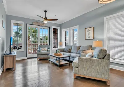 a living room with a couch and a tv at Stunning Village Condo, Overlooking 30A, Beautifully Decorated Recently Updated in Rosemary Beach