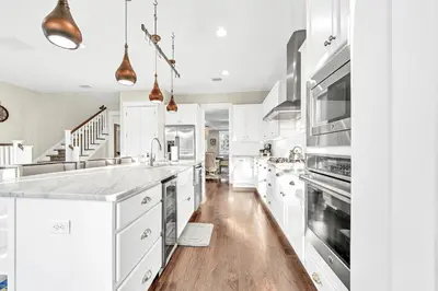 a kitchen with white cabinets and stainless steel appliances at NatureWalk on 30A Overlooking Beautiful Pond! in Seagrove Beach
