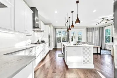 a kitchen with white cabinets and a kitchen island at NatureWalk on 30A Overlooking Beautiful Pond! in Seagrove Beach