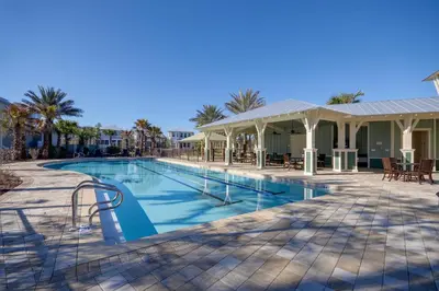a swimming pool at a resort with palm trees at NatureWalk on 30A Overlooking Beautiful Pond! in Seagrove Beach