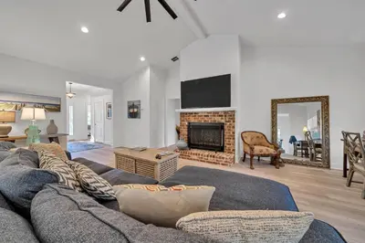 a living room with a couch and a fireplace at New Seagrove Beach Construction, Easy Beach Access, Professionally Decorated - Amazing Privacy! in Santa Rosa Beach