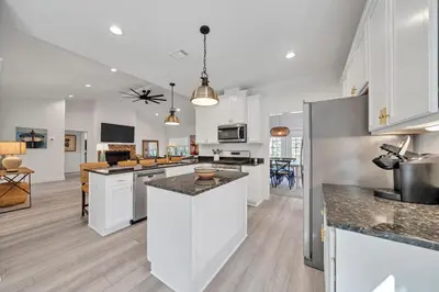 a kitchen with white cabinets and a kitchen island at New Seagrove Beach Construction, Easy Beach Access, Professionally Decorated - Amazing Privacy! in Santa Rosa Beach