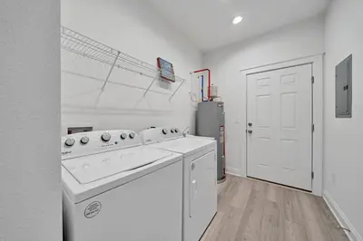 a white kitchen with a stove and a refrigerator at New Seagrove Beach Construction, Easy Beach Access, Professionally Decorated - Amazing Privacy! in Santa Rosa Beach