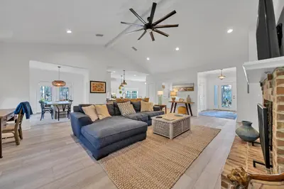 a living room with a blue couch and a table at New Seagrove Beach Construction, Easy Beach Access, Professionally Decorated - Amazing Privacy! in Santa Rosa Beach