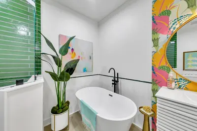 a bathroom with a white toilet and a plant at Newly Renovated Professionally Decorated Gulf Views! Pool & Beach Access in Rosemary Beach