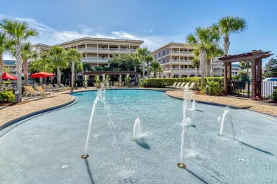 a pool with water fountains in front of a building at Newly Renovated Professionally Decorated Gulf Views! Pool & Beach Access in Rosemary Beach