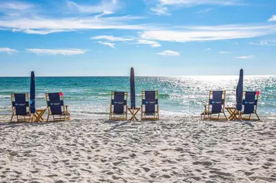 a group of beach chairs sitting on the beach at Newly Renovated Professionally Decorated Gulf Views! Pool & Beach Access in Rosemary Beach