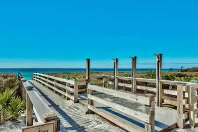 a boardwalk to the beach with the ocean in the background at Newly Renovated Professionally Decorated Gulf Views! Pool & Beach Access in Rosemary Beach