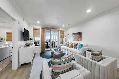 a living room with couches and a kitchen at Newly Renovated Professionally Decorated Gulf Views! Pool & Beach Access in Rosemary Beach