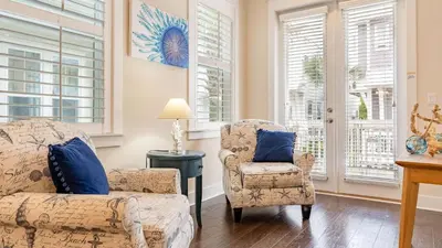 a living room with two chairs and a couch at Emerald Gem by AvantStay Pool Access 3mins to Beach in Panama City Beach