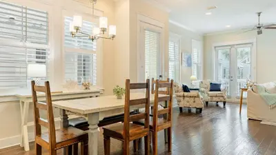 a kitchen and dining room with a table and chairs at Emerald Gem by AvantStay Pool Access 3mins to Beach in Panama City Beach