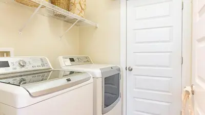 a laundry room with a washer and dryer at Emerald Gem by AvantStay Pool Access 3mins to Beach in Panama City Beach