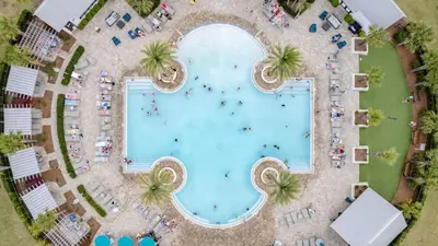 an overhead view of a swimming pool with palm trees at Emerald Gem by AvantStay Pool Access 3mins to Beach in Panama City Beach