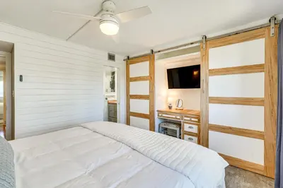 a bedroom with a bed and a flat screen tv at Beachfront Panama City Condo with Balcony and Views! in Panama City